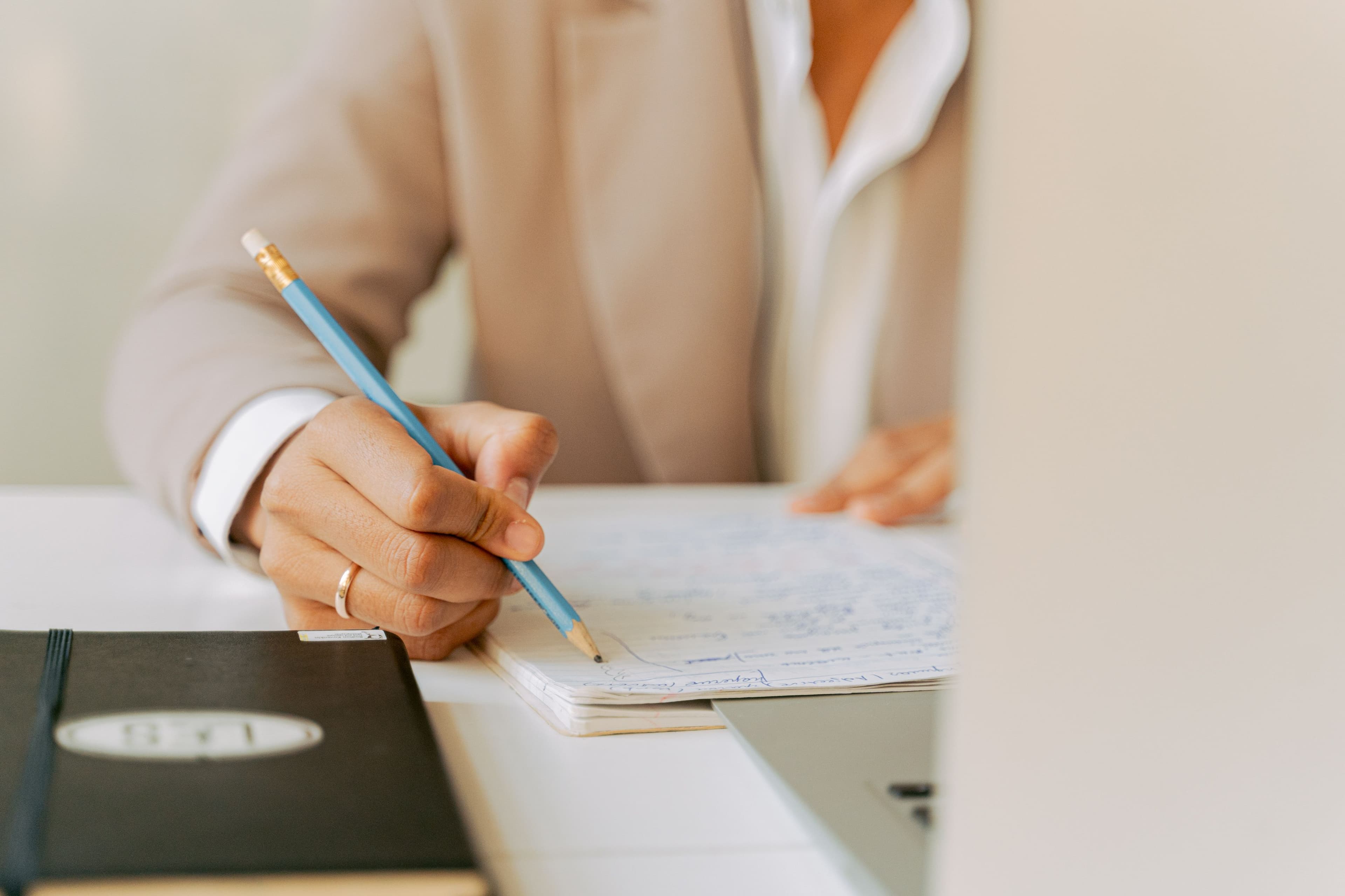 Hands signing a corporate legal document